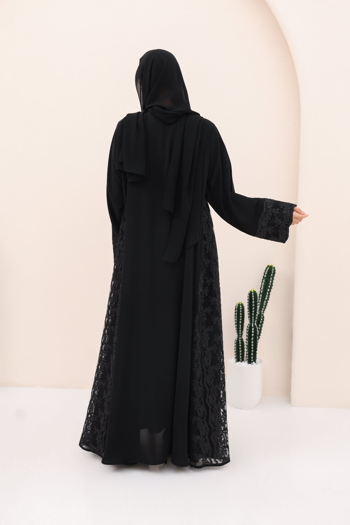 Black abaya with lace details on a white background