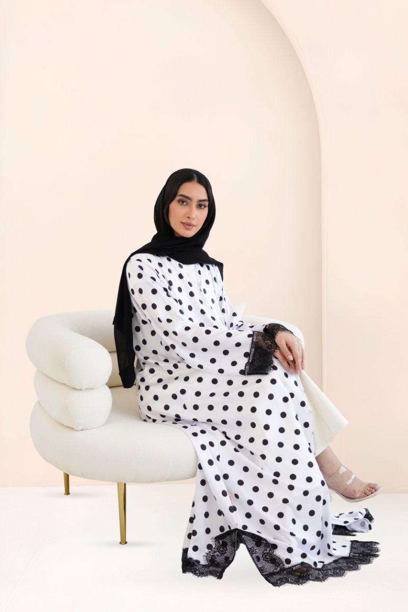 Riwa Classic Polka dot silk abaya set shown in motion, highlighting the drape and lace-trimmed sheila